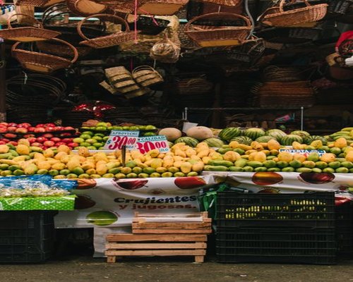 A vibrant display of fresh local produce and tropical fruits in a bustling Colombian market