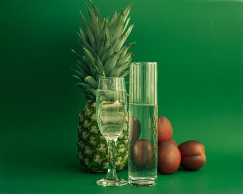 Fresh water glass next to a piece of tropical fruit